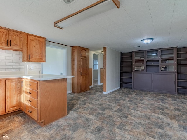 kitchen featuring decorative backsplash and kitchen peninsula