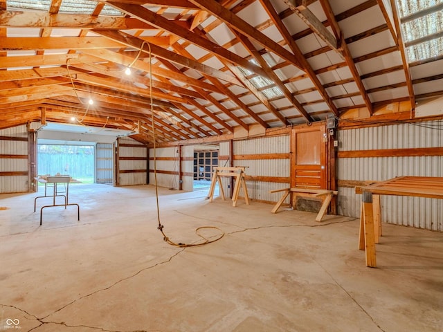 misc room featuring concrete floors and vaulted ceiling