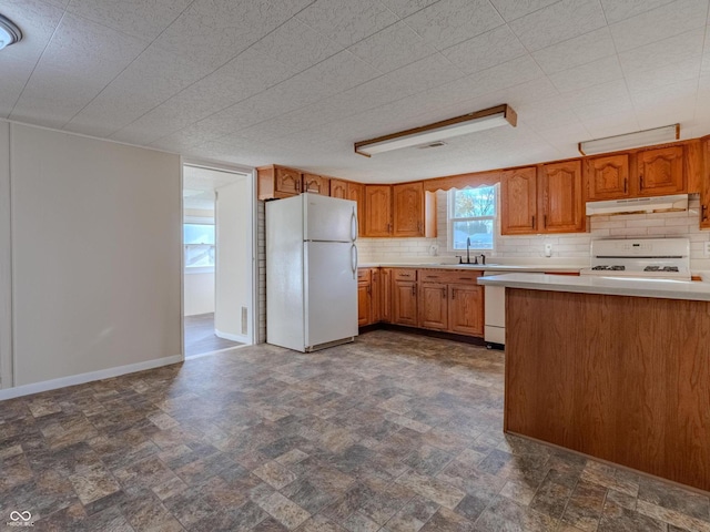 kitchen with white appliances, sink, and decorative backsplash