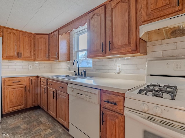 kitchen with decorative backsplash, white appliances, and sink