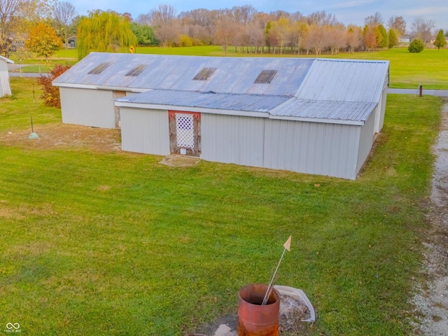 view of outbuilding with a yard