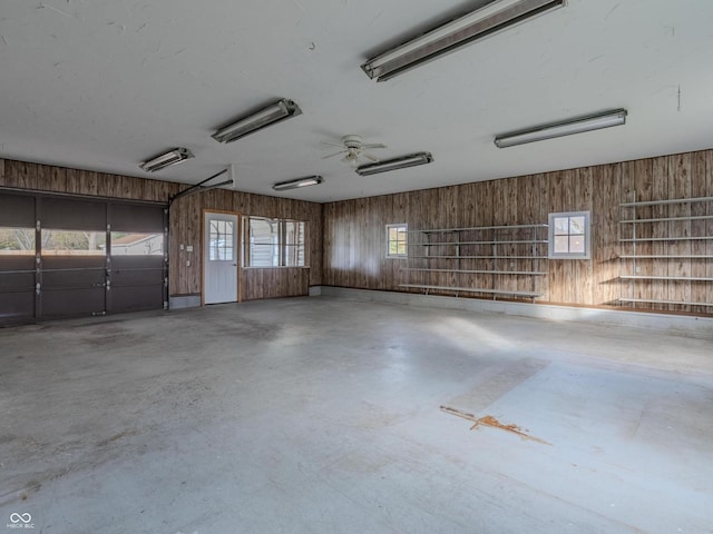 garage with wood walls and ceiling fan