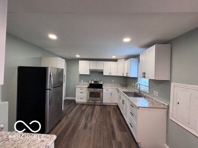 kitchen with dark hardwood / wood-style floors, white cabinetry, sink, and appliances with stainless steel finishes