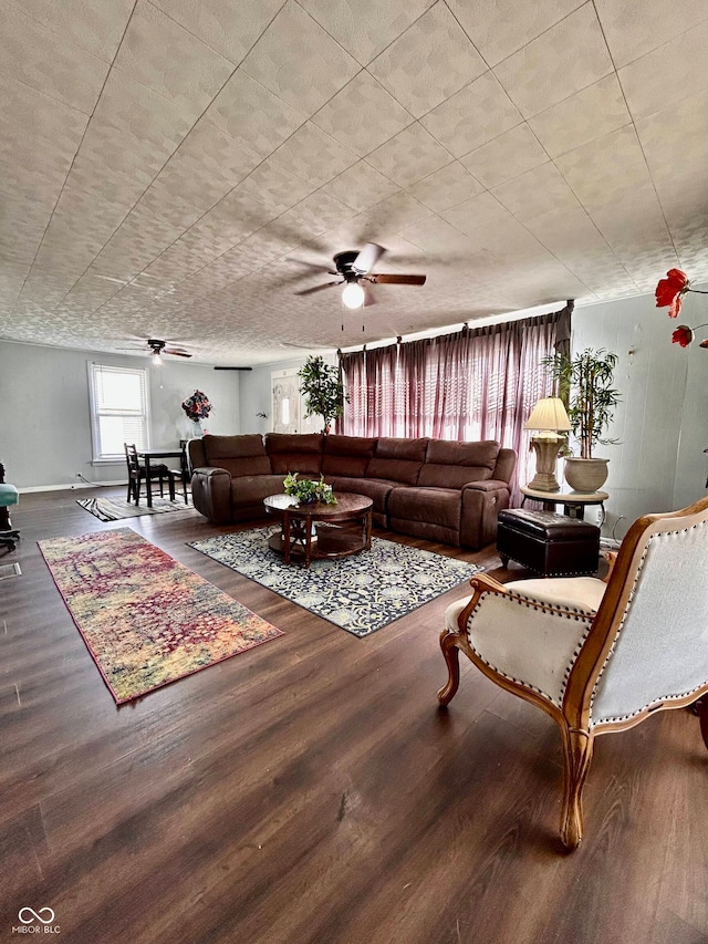 living room featuring hardwood / wood-style floors and ceiling fan