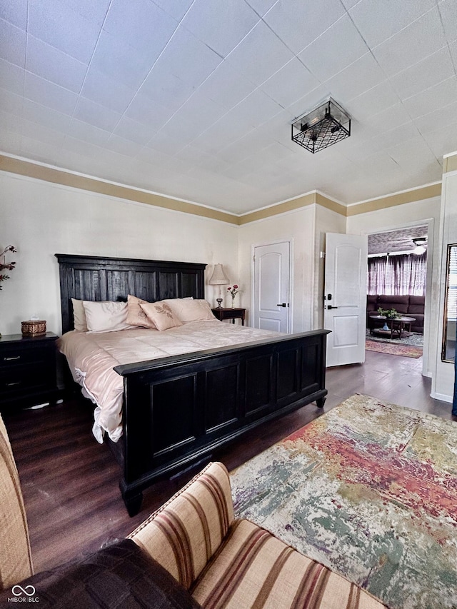 bedroom featuring dark hardwood / wood-style flooring and ornamental molding