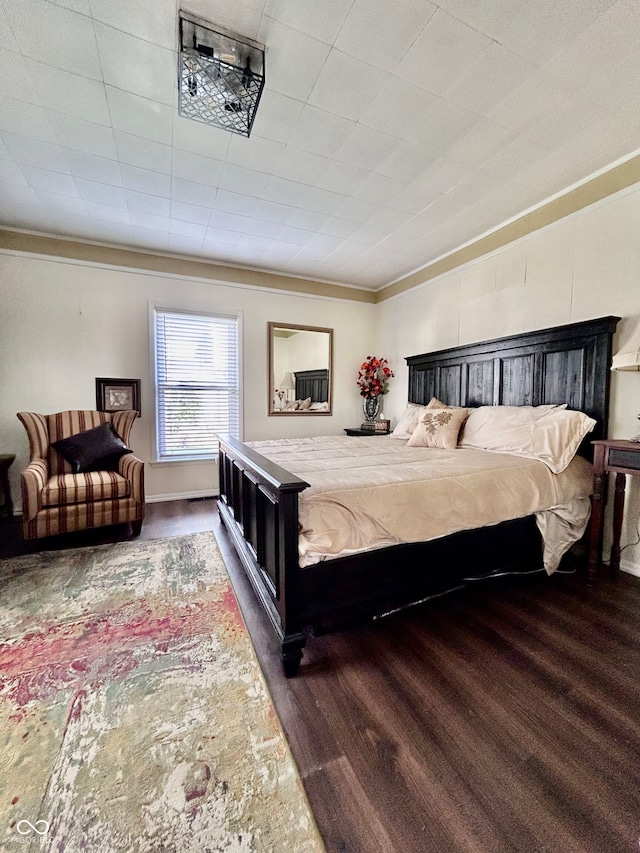 bedroom with dark hardwood / wood-style floors