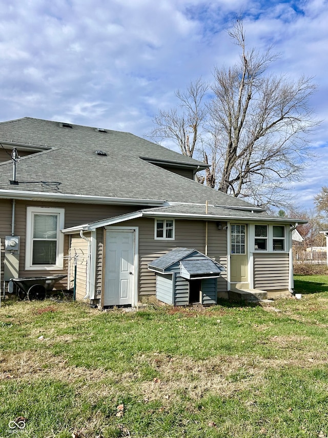 rear view of property with a yard