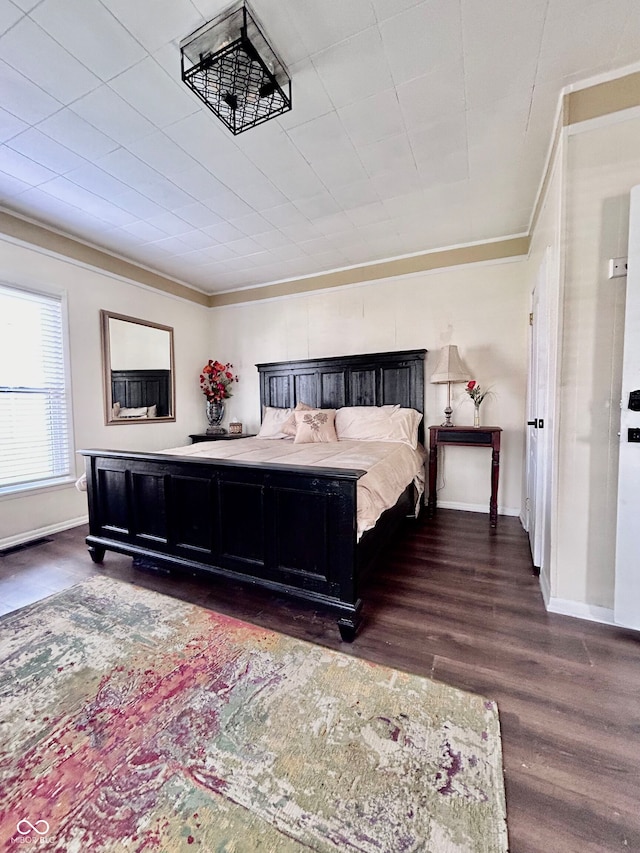 bedroom featuring dark hardwood / wood-style flooring and crown molding