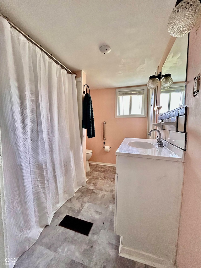 bathroom featuring toilet and vanity