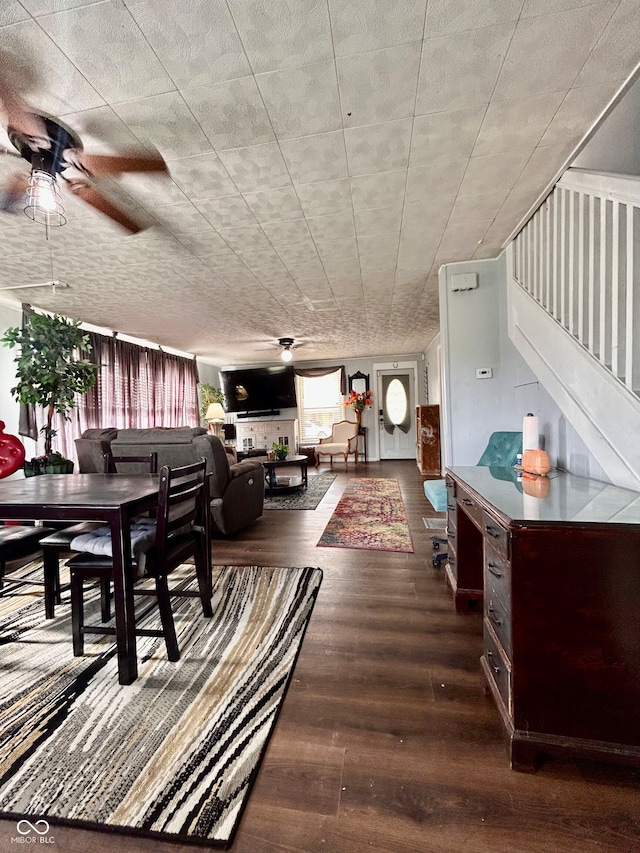 dining area with dark wood-type flooring and ceiling fan