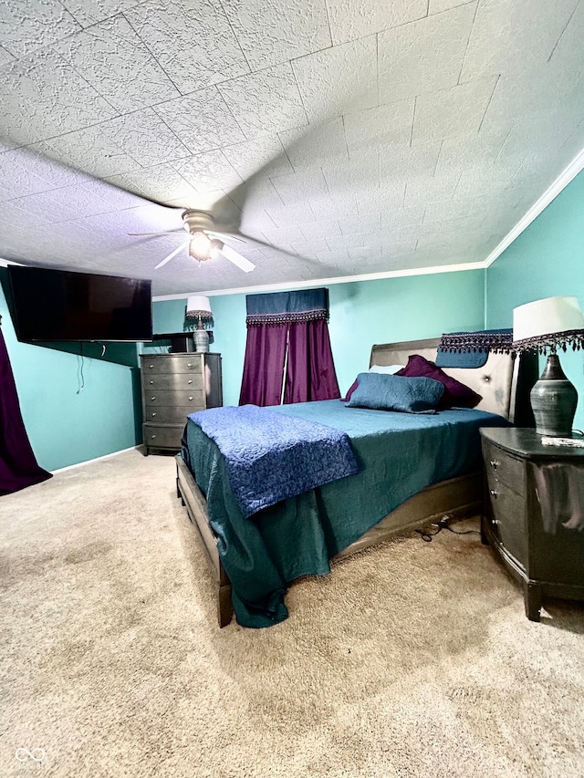 carpeted bedroom featuring ornamental molding, a textured ceiling, and ceiling fan