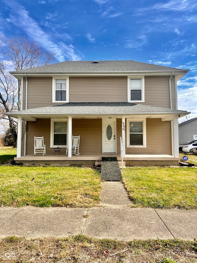 view of front of property with a front yard and covered porch