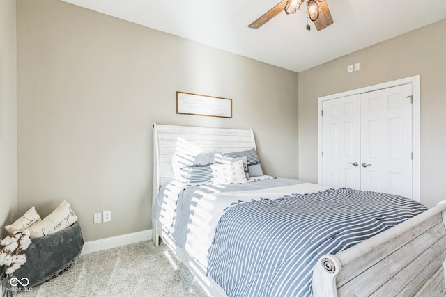 carpeted bedroom featuring ceiling fan and a closet