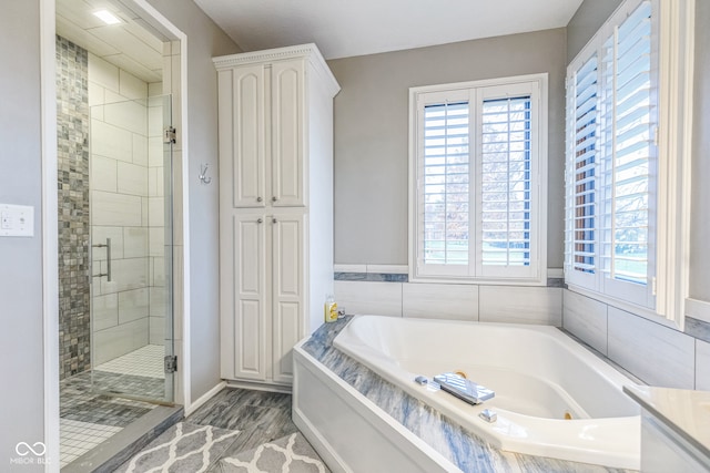 bathroom featuring plenty of natural light and plus walk in shower