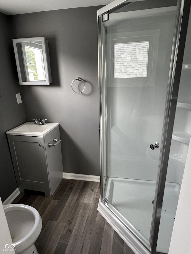 bathroom with vanity, hardwood / wood-style flooring, an enclosed shower, and a bidet