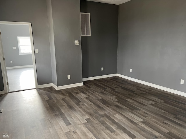 empty room with dark hardwood / wood-style floors