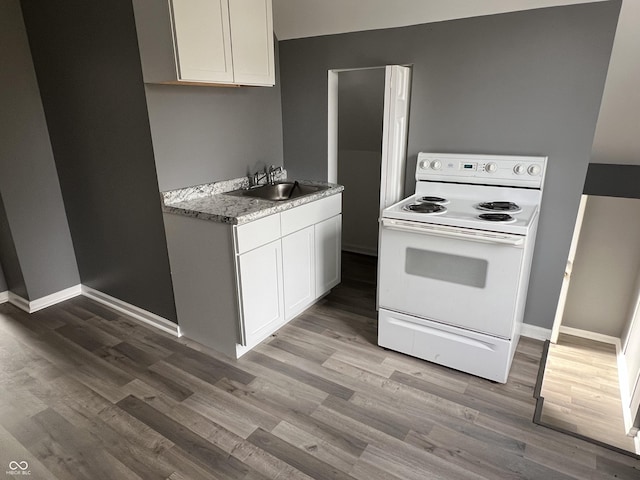 kitchen with white cabinetry, sink, wood-type flooring, and white electric stove