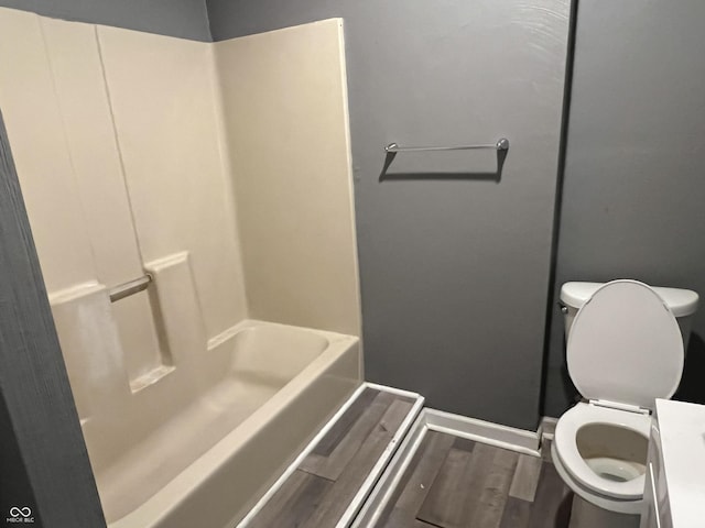 bathroom with hardwood / wood-style floors and toilet