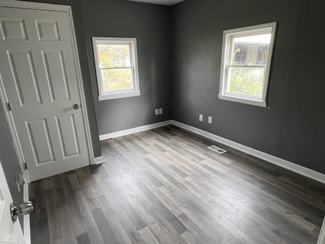 spare room with hardwood / wood-style floors