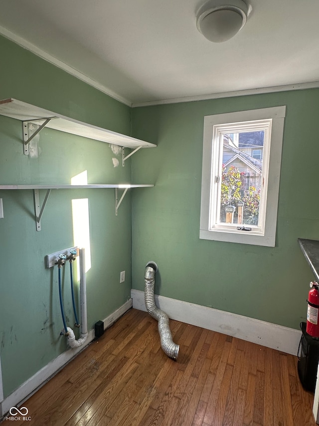 washroom with a wealth of natural light, washer hookup, and hardwood / wood-style flooring