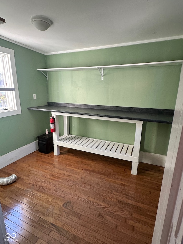 clothes washing area with dark wood-type flooring and ornamental molding