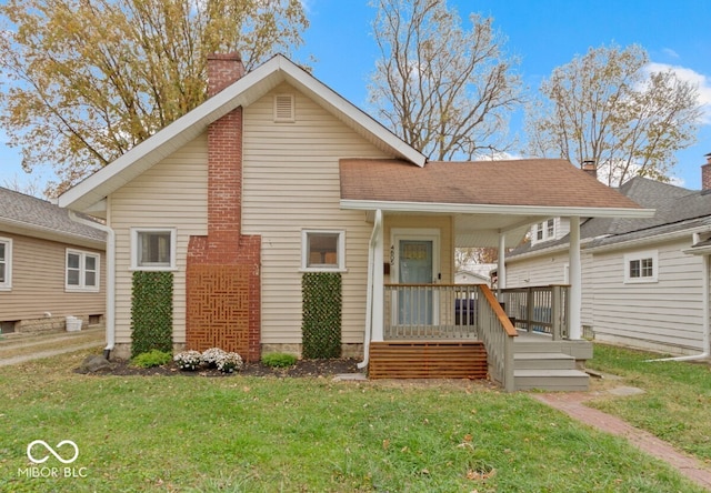 view of front facade with a front yard and a porch