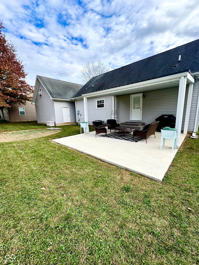 rear view of property featuring a patio and a yard