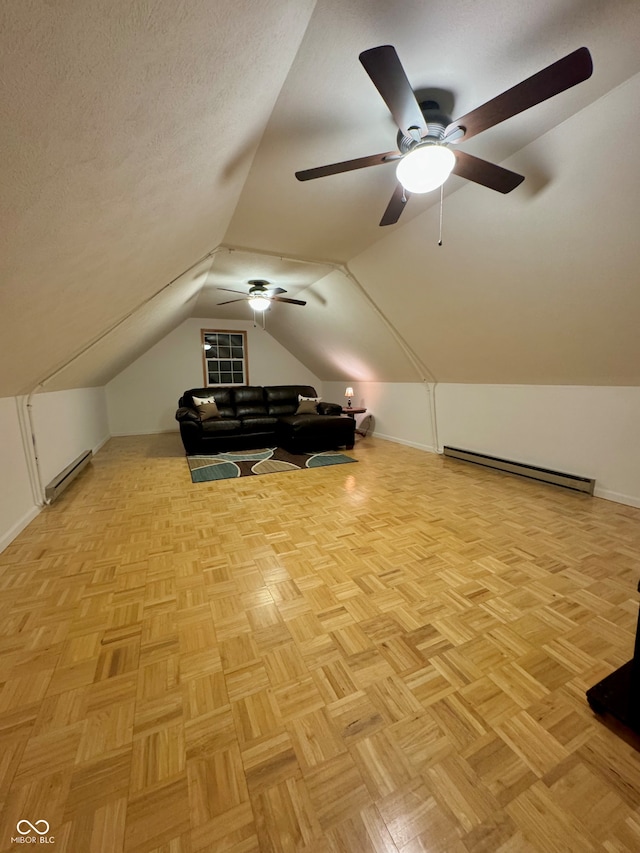 bonus room with light parquet floors, a baseboard radiator, a textured ceiling, and lofted ceiling