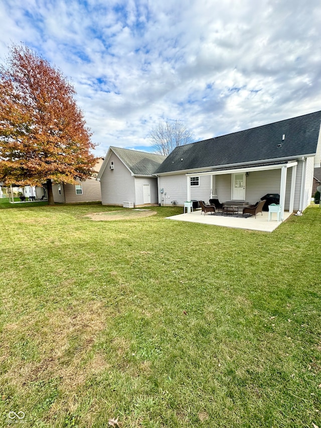 rear view of house with a yard and a patio area