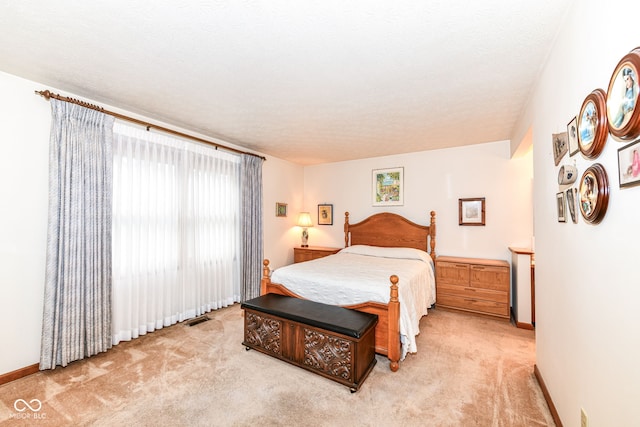 carpeted bedroom with a textured ceiling