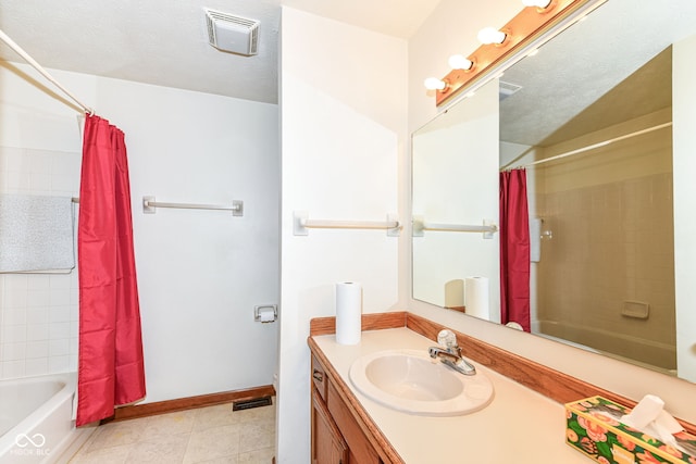 bathroom with vanity, tile patterned flooring, shower / bath combo, and a textured ceiling