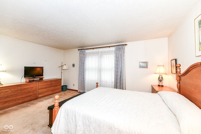 carpeted bedroom featuring a textured ceiling