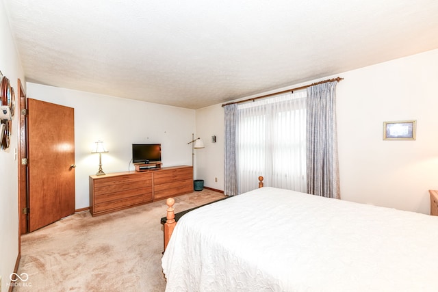 carpeted bedroom featuring a textured ceiling