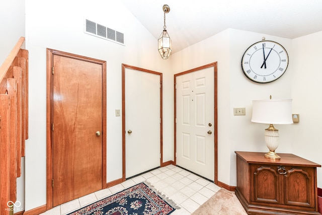 foyer entrance featuring lofted ceiling and light tile patterned floors