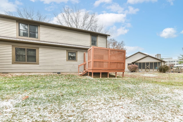 rear view of house with a wooden deck and a yard