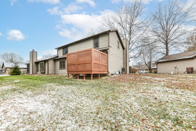 rear view of house featuring a wooden deck