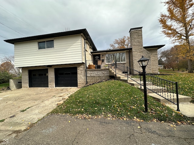 view of side of home featuring a lawn, a garage, and a porch