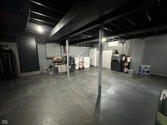 basement with white fridge and independent washer and dryer