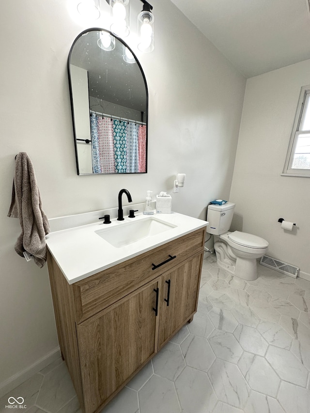 bathroom featuring vanity and toilet