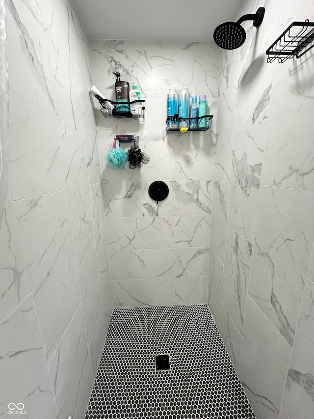 bathroom with a tile shower