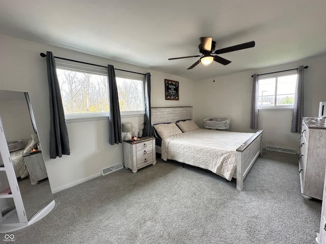 bedroom featuring multiple windows, ceiling fan, and carpet floors