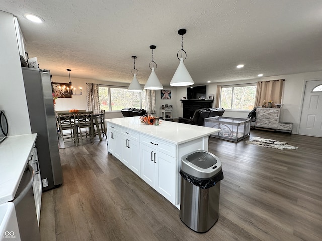 kitchen featuring dark hardwood / wood-style flooring, white cabinetry, stainless steel refrigerator, and plenty of natural light