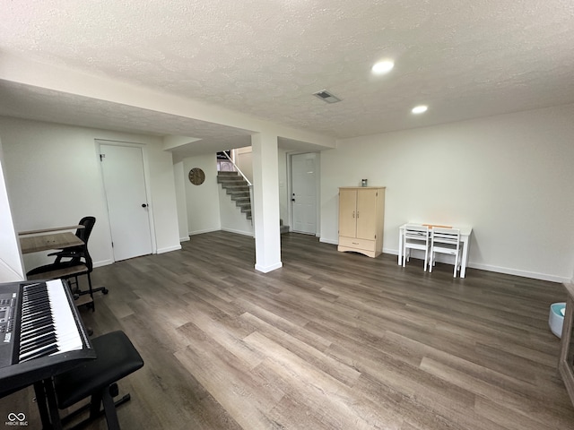 office space with dark wood-type flooring and a textured ceiling