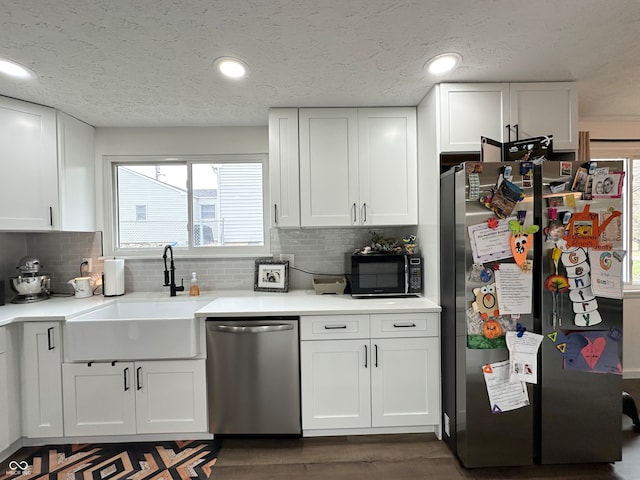 kitchen with dark hardwood / wood-style flooring, white cabinetry, sink, and appliances with stainless steel finishes