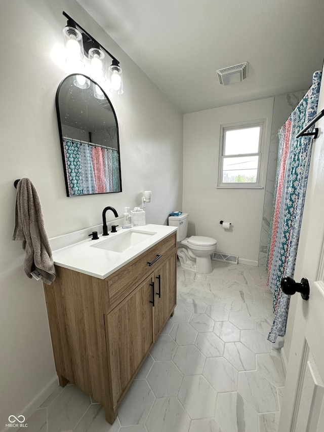 bathroom featuring curtained shower, vanity, and toilet