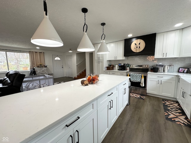 kitchen featuring decorative light fixtures, decorative backsplash, white cabinets, dark wood-type flooring, and electric range