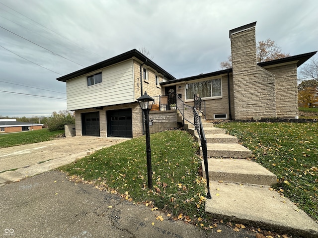 split level home featuring a garage and a front yard