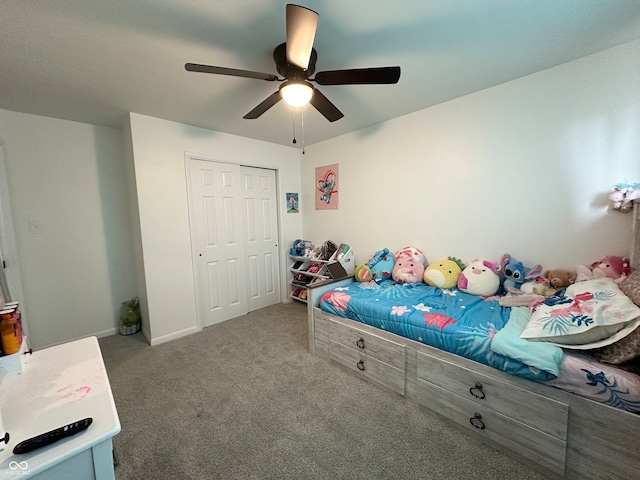 carpeted bedroom with ceiling fan and a closet