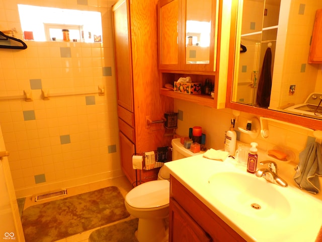 bathroom with decorative backsplash, tile patterned floors, vanity, a shower, and toilet