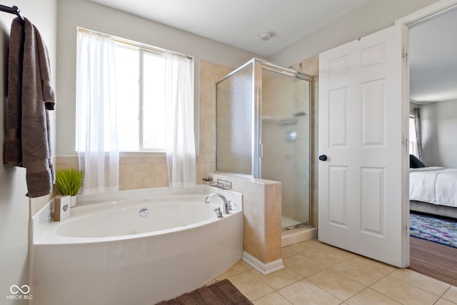 bathroom with tile patterned floors, plenty of natural light, and plus walk in shower